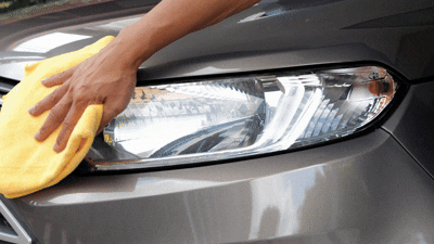 car headlight getting wiped down after a polish