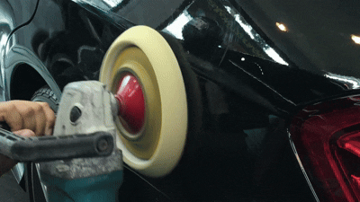 exterior of a car getting polished by a polisher